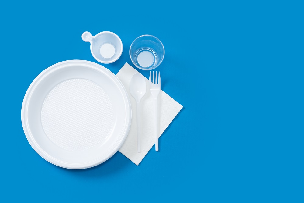 Traditional disposable plastic plates, sauce cups, forks and spoons.