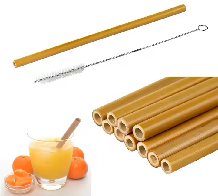 Bamboo drinking straws on a glass of orange juice.