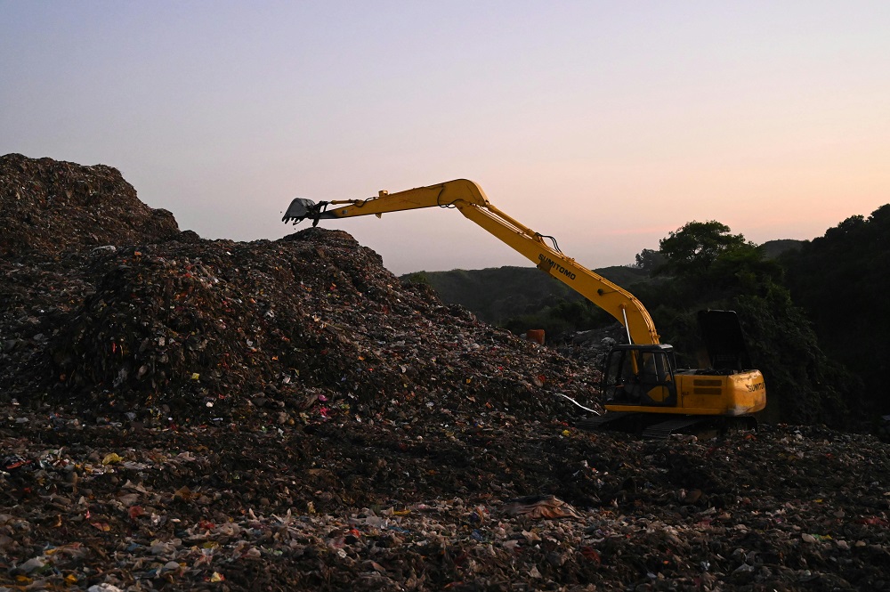 Excavators dispose of waste, including disposable tableware, at landfills.
