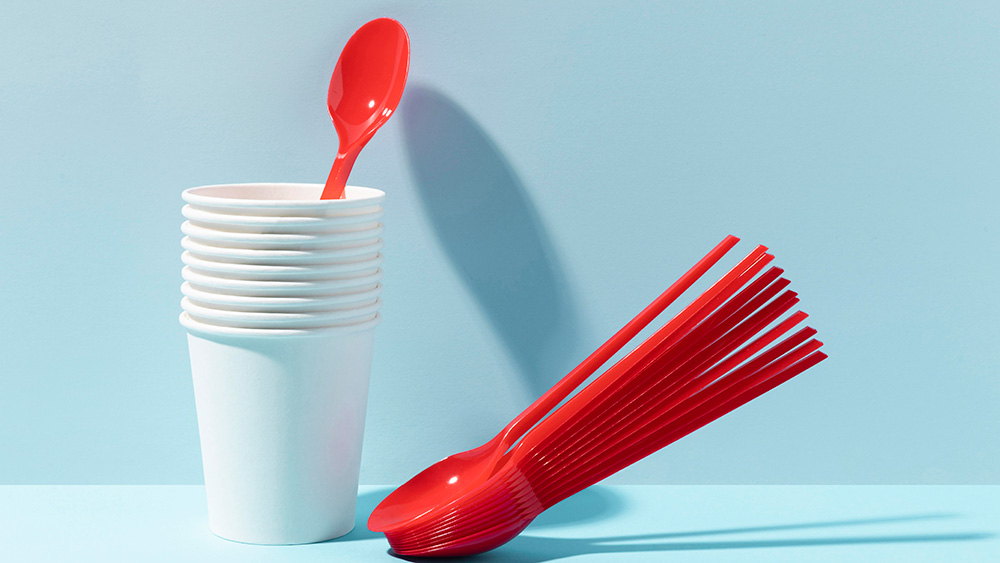 Red plastic spoons in white paper cups