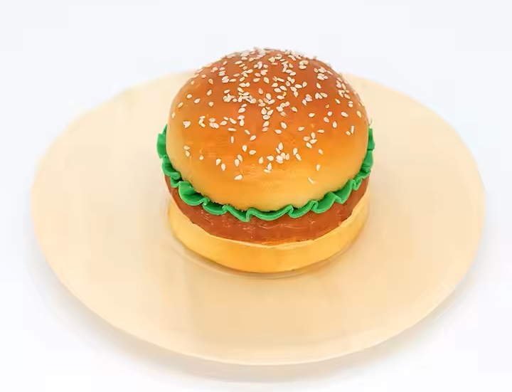 A burger on disposable wooden plate.