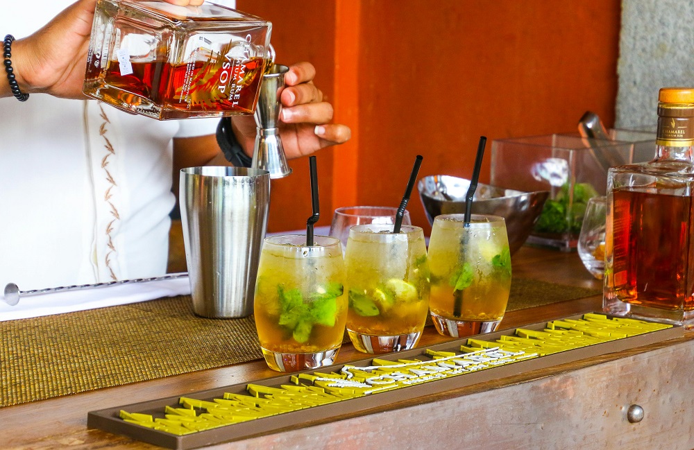 Bartenders are making drinks for customers at the hotel bar.
