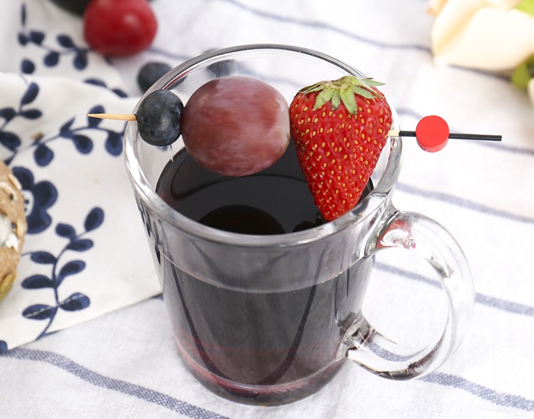 The fancy cocktail stick provides a fruit garnish for the drink.