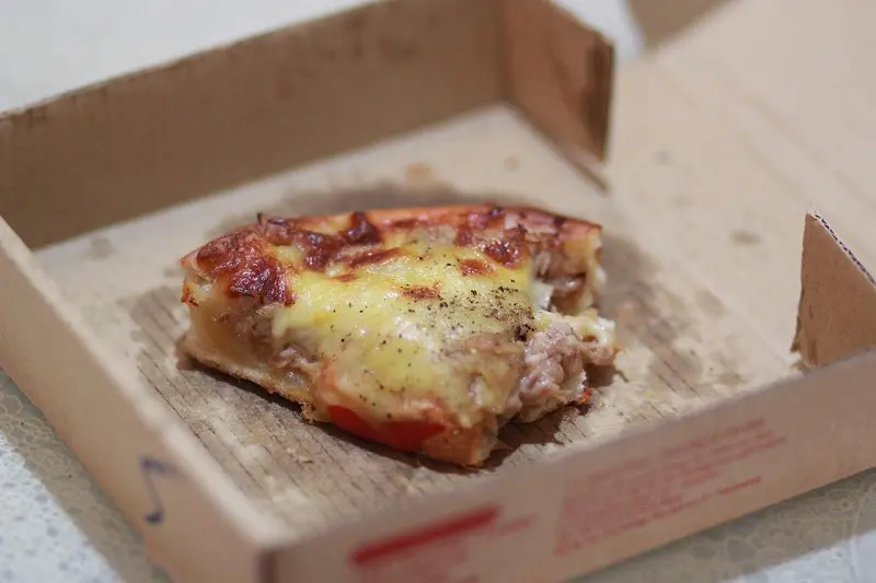 Grease-stained small pizza boxes