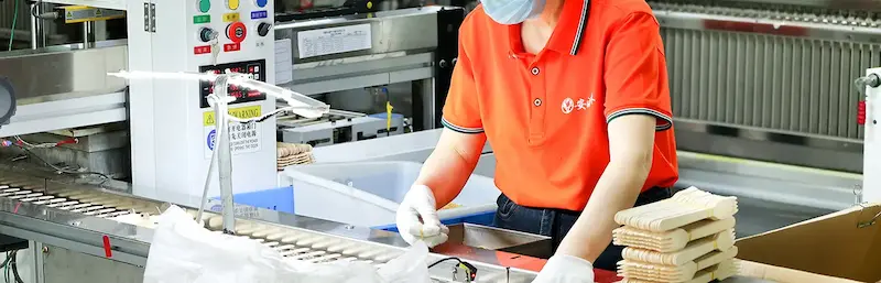 Quality control personnel are inspecting the quality of wooden forks.