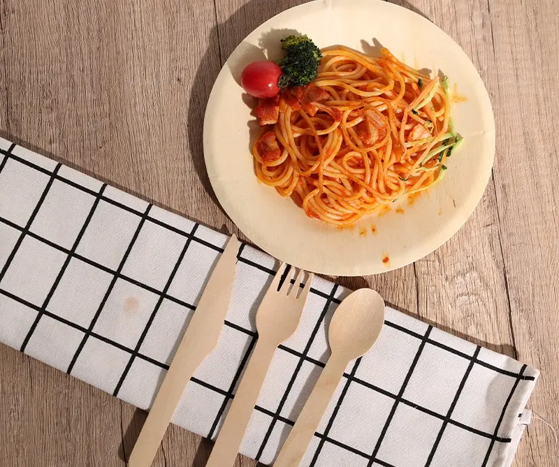 Enjoying pasta on wooden disposable plates and utensils